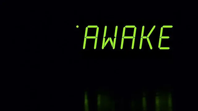 An alarm clock displays "Awake"